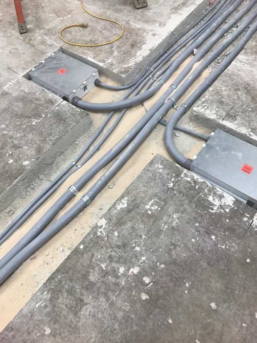 Clean conduit runs and floor-box infrastructure before final finish.